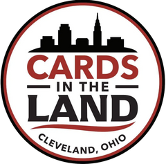 Logo for 'Cards in the Land' with a city skyline silhouette on a white background